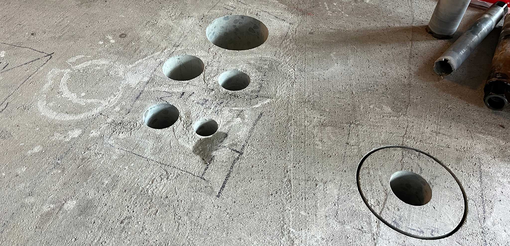 Clean concrete core holes in a range of diameters drilled through a scanned slab